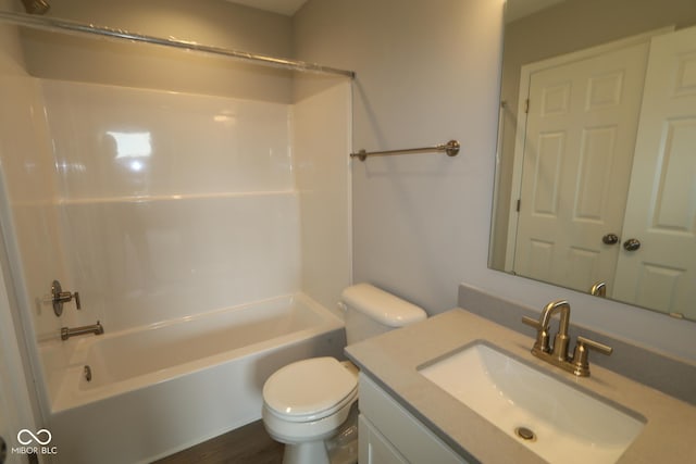 full bathroom featuring washtub / shower combination, vanity, and toilet