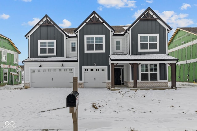 view of front of property with a garage, covered porch, board and batten siding, and brick siding