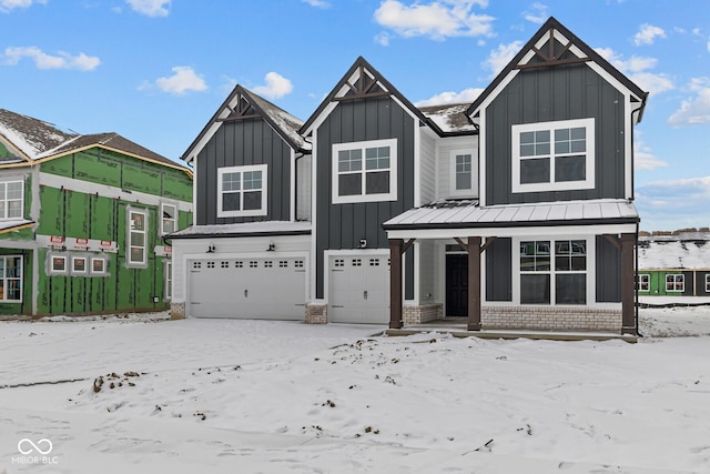 view of front of house featuring metal roof, an attached garage, a standing seam roof, board and batten siding, and brick siding