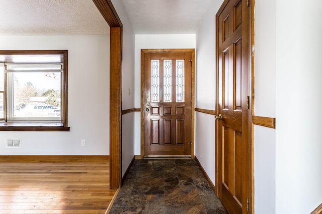 entryway featuring a textured ceiling