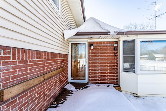 view of snow covered property entrance