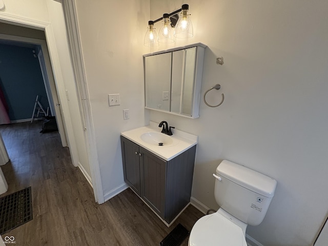 bathroom featuring hardwood / wood-style floors, vanity, and toilet