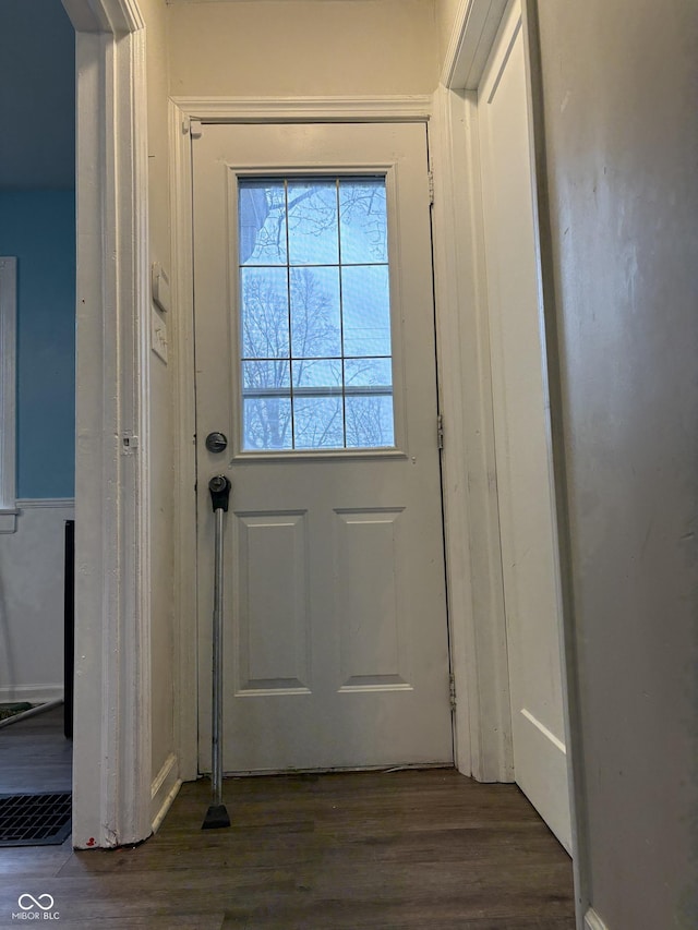 doorway with dark wood-type flooring