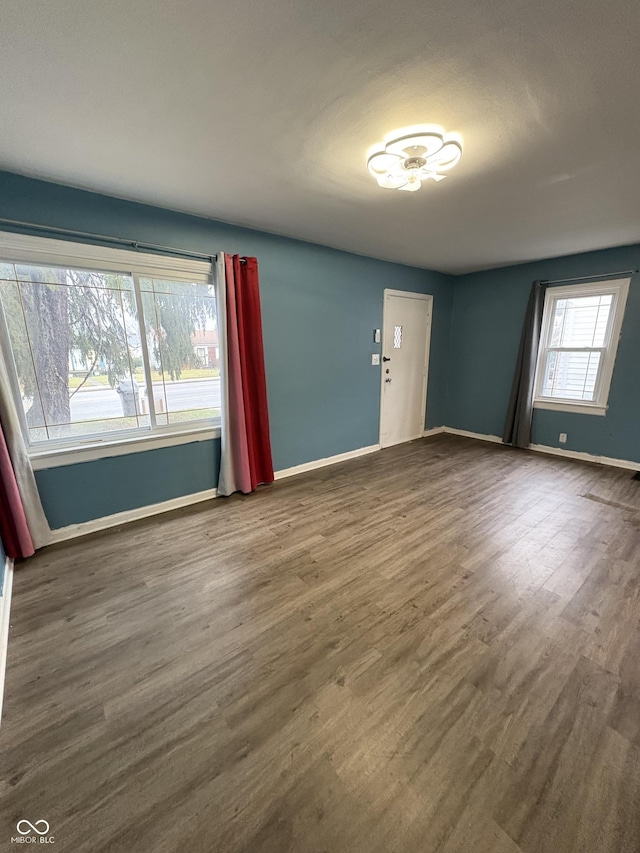 empty room with dark wood-type flooring