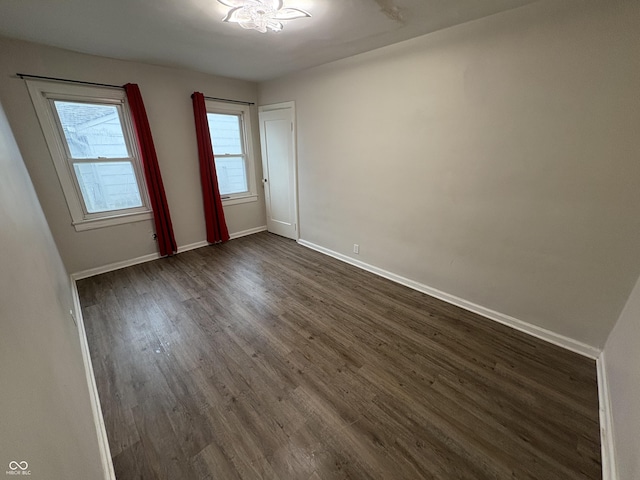 empty room with dark wood-type flooring