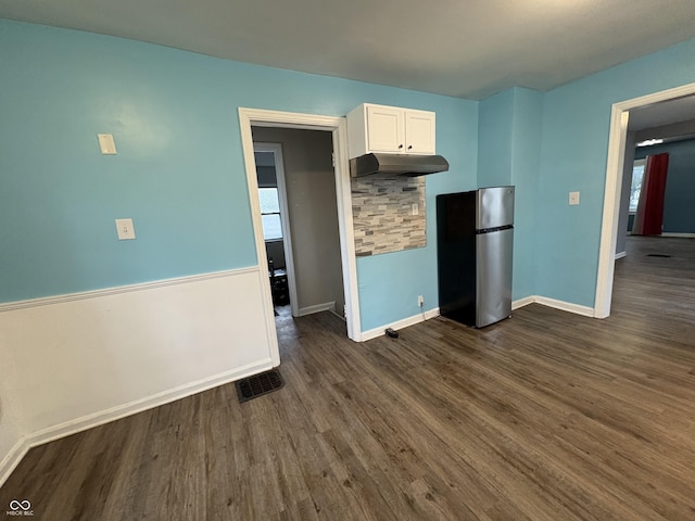 3919 E 34th St, Indianapolis, IN 46218 - kitchen featuring freestanding refrigerator, white cabinetry, dark wood-style floors, and under cabinet range hood