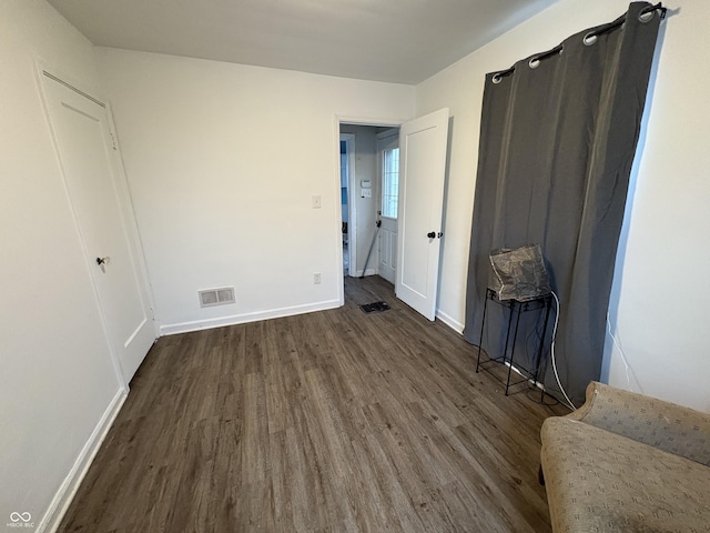 unfurnished bedroom with dark hardwood / wood-style floors