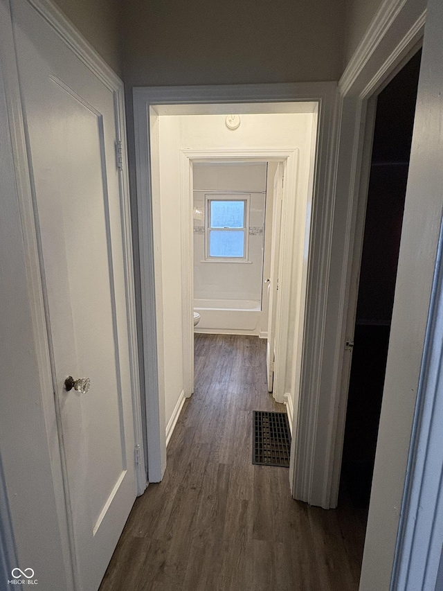 3919 E 34th St, Indianapolis, IN 46218 - hallway with dark wood-style flooring and baseboards