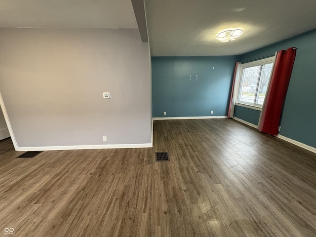 unfurnished room with dark hardwood / wood-style flooring