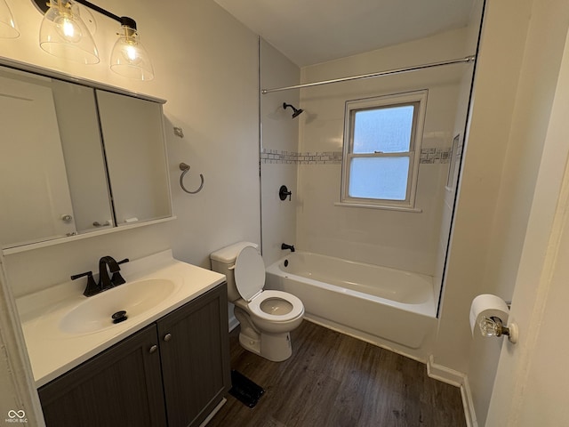 full bathroom with tiled shower / bath, toilet, vanity, and hardwood / wood-style flooring