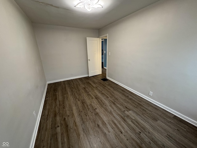 spare room with dark hardwood / wood-style flooring