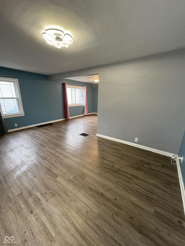 3919 E 34th St, Indianapolis, IN 46218 - unfurnished room with baseboards and dark wood-style flooring