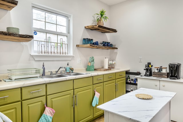 kitchen featuring green cabinets and sink