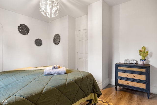 bedroom with a chandelier and hardwood / wood-style flooring