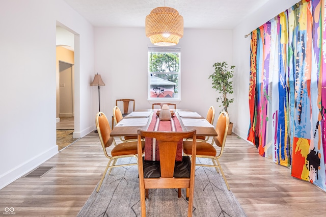 dining space with light hardwood / wood-style flooring