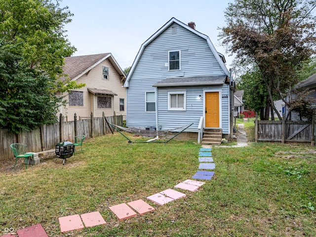 rear view of house with a lawn