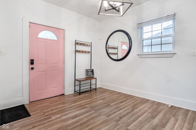 foyer featuring a chandelier and light hardwood / wood-style floors