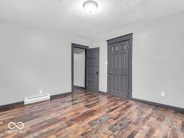 unfurnished room featuring a textured ceiling, a baseboard radiator, and dark hardwood / wood-style floors