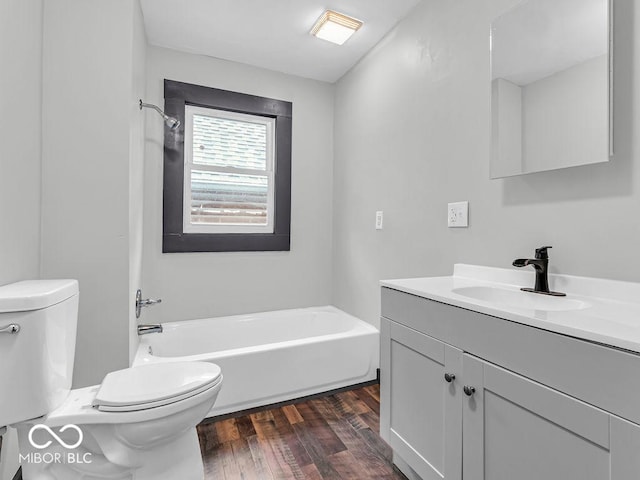 bathroom featuring toilet, vanity, and hardwood / wood-style flooring