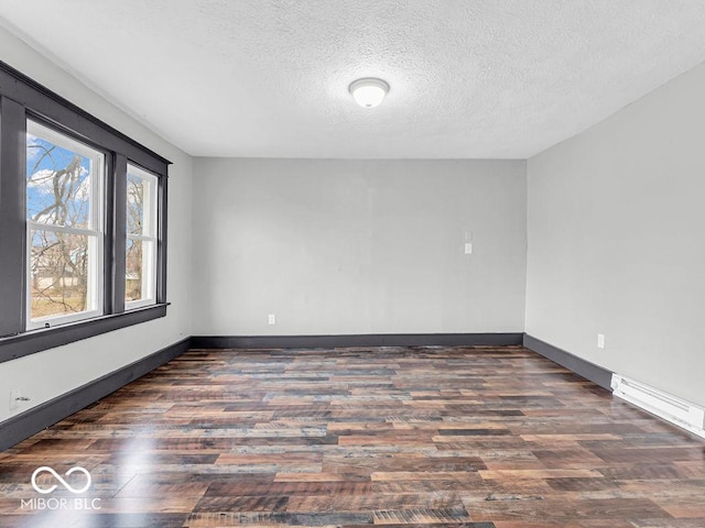 unfurnished room with a textured ceiling and dark hardwood / wood-style flooring