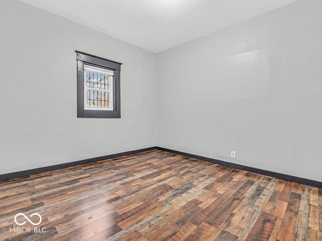 spare room featuring dark wood-type flooring