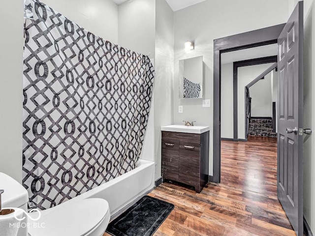 full bathroom with toilet, vanity, shower / bath combination with curtain, and hardwood / wood-style floors