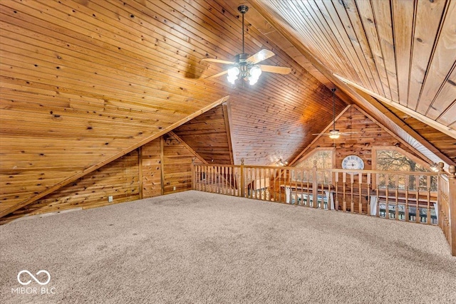 additional living space with vaulted ceiling, ceiling fan, wooden ceiling, carpet floors, and wood walls