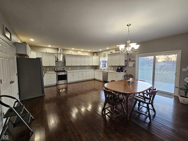 dining space with a chandelier, dark hardwood / wood-style floors, and sink