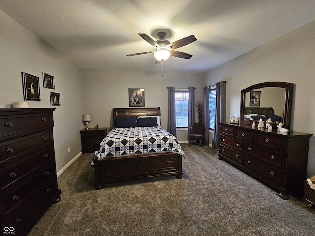 bedroom featuring ceiling fan, a textured ceiling, and dark colored carpet