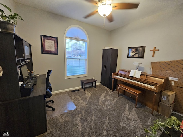 carpeted home office featuring ceiling fan