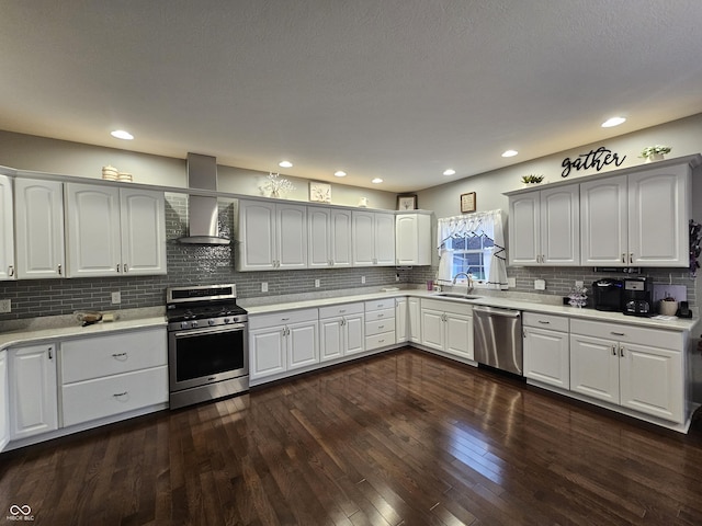 kitchen with white cabinetry, sink, wall chimney exhaust hood, and appliances with stainless steel finishes