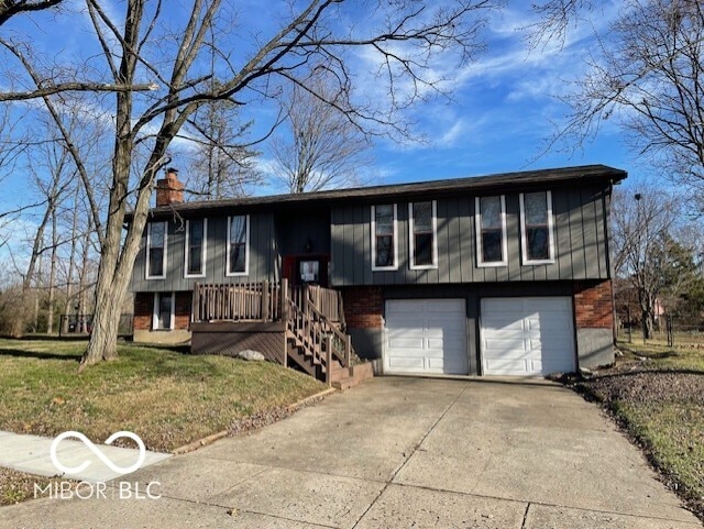 split foyer home with a front yard and a garage