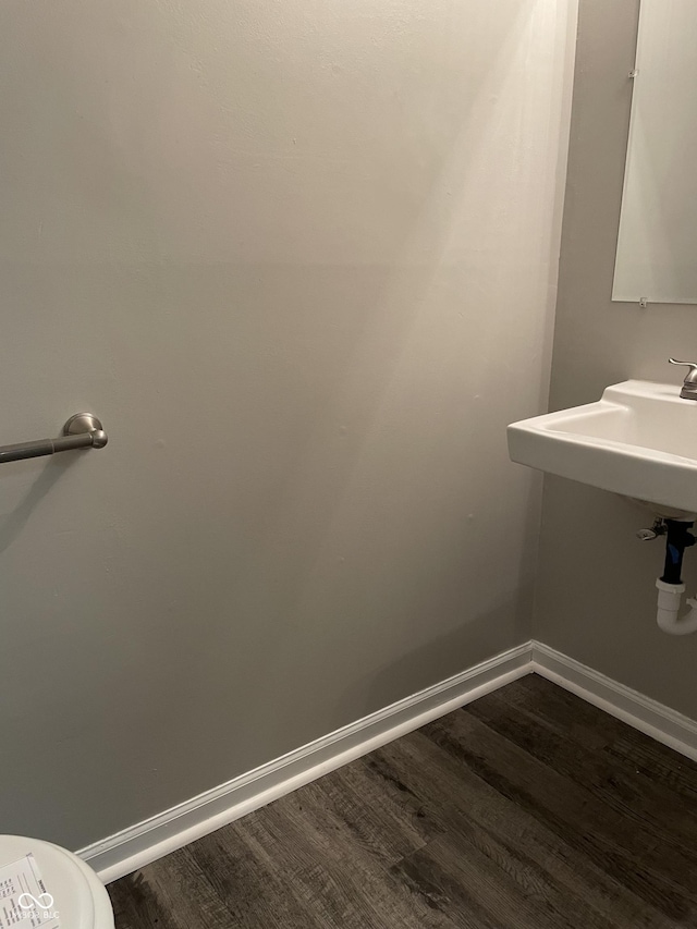 bathroom with hardwood / wood-style floors and toilet