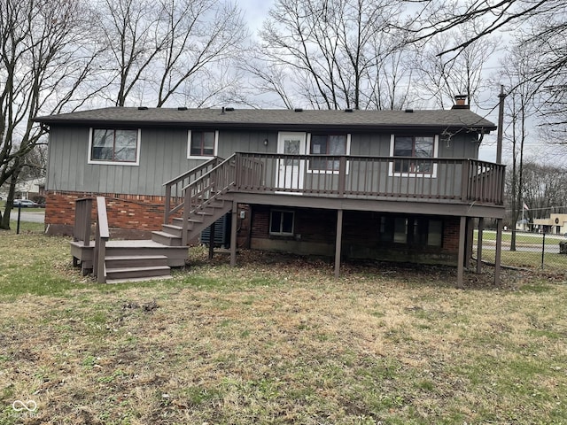 back of house with a deck and a yard