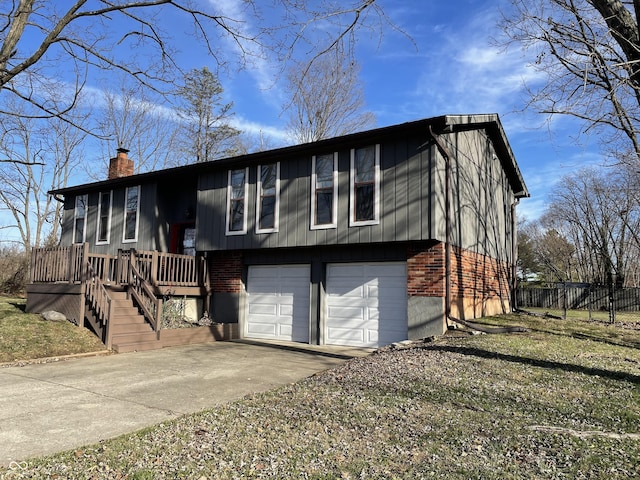 bi-level home featuring a garage and a wooden deck