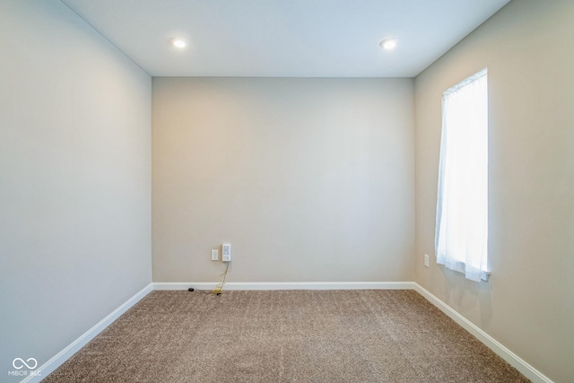 carpeted spare room with a healthy amount of sunlight