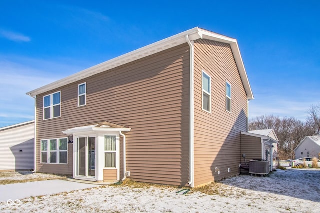 back of house featuring central AC unit