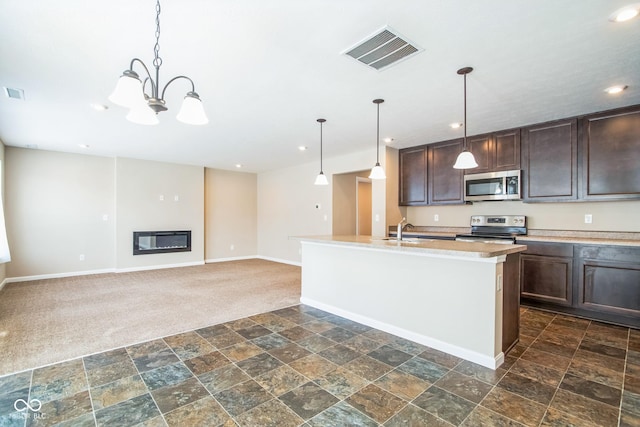 kitchen with a center island with sink, an inviting chandelier, decorative light fixtures, and appliances with stainless steel finishes