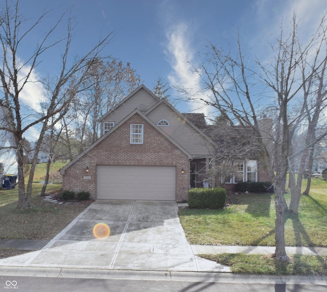 view of property featuring a front yard and a garage