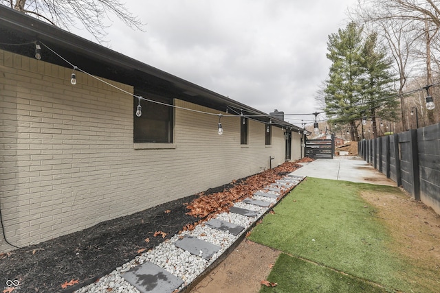 view of home's exterior featuring a lawn and a patio area