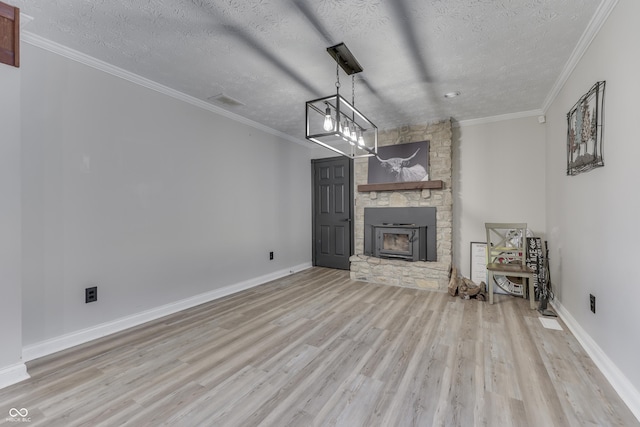 unfurnished living room with a textured ceiling, a fireplace, and light hardwood / wood-style flooring