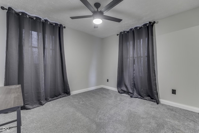 spare room with carpet flooring, ceiling fan, and a textured ceiling