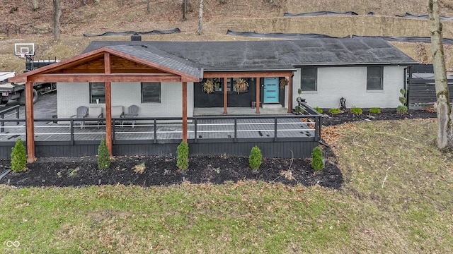 rear view of house with a gazebo and a deck