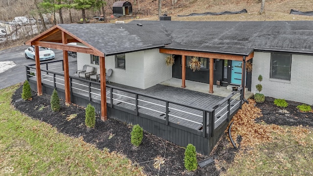 rear view of house featuring a deck