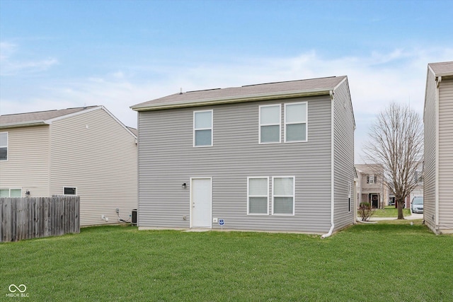 rear view of house with a yard