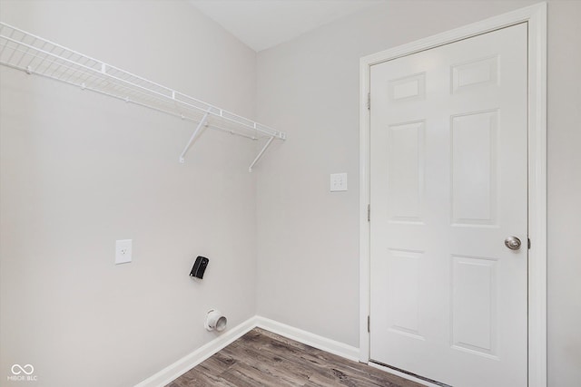 laundry area featuring electric dryer hookup and wood-type flooring