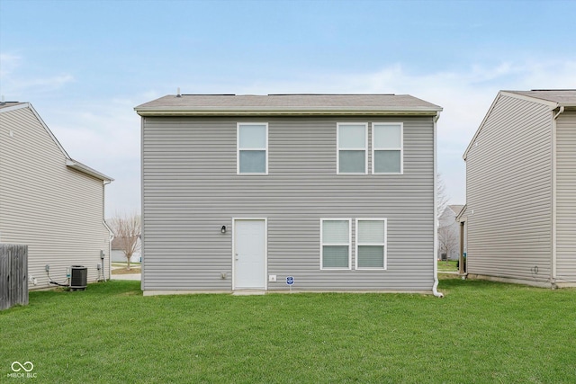 rear view of house featuring a yard and cooling unit