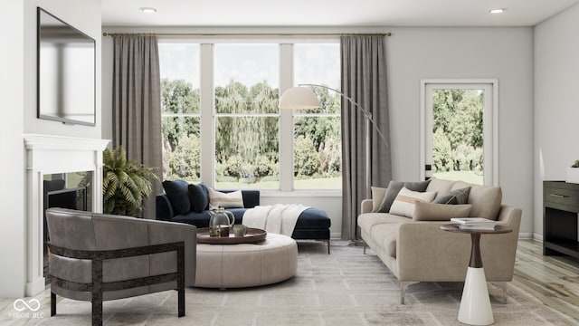 living area featuring a high end fireplace and light hardwood / wood-style flooring