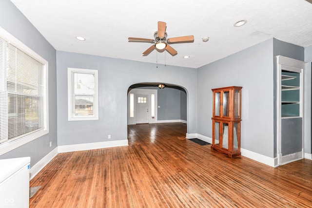 empty room featuring hardwood / wood-style flooring, ceiling fan, and a textured ceiling