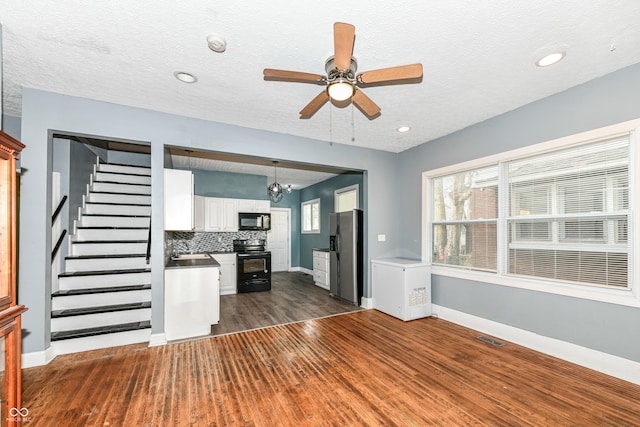 3458 N Kenwood Ave, Indianapolis, IN 46208 - unfurnished living room with ceiling fan, dark wood-style floors, stairway, a textured ceiling, and recessed lighting